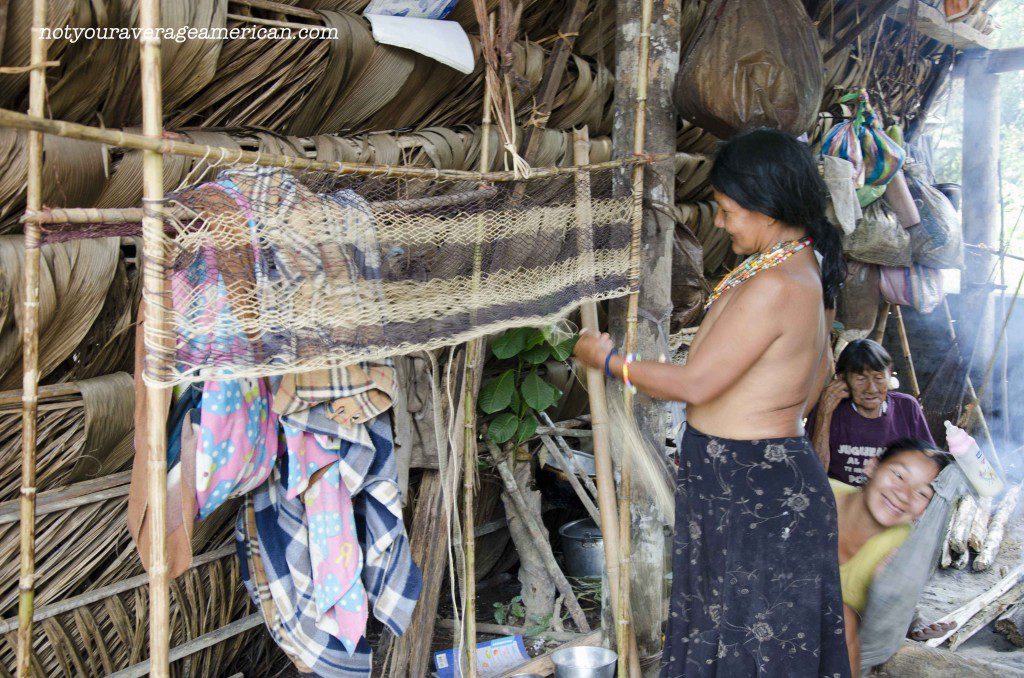 The Huaorani harvest fiber from the jungle, turn it into rope, and then use it to make other items. This woman is working on a soon-to-be hammock.